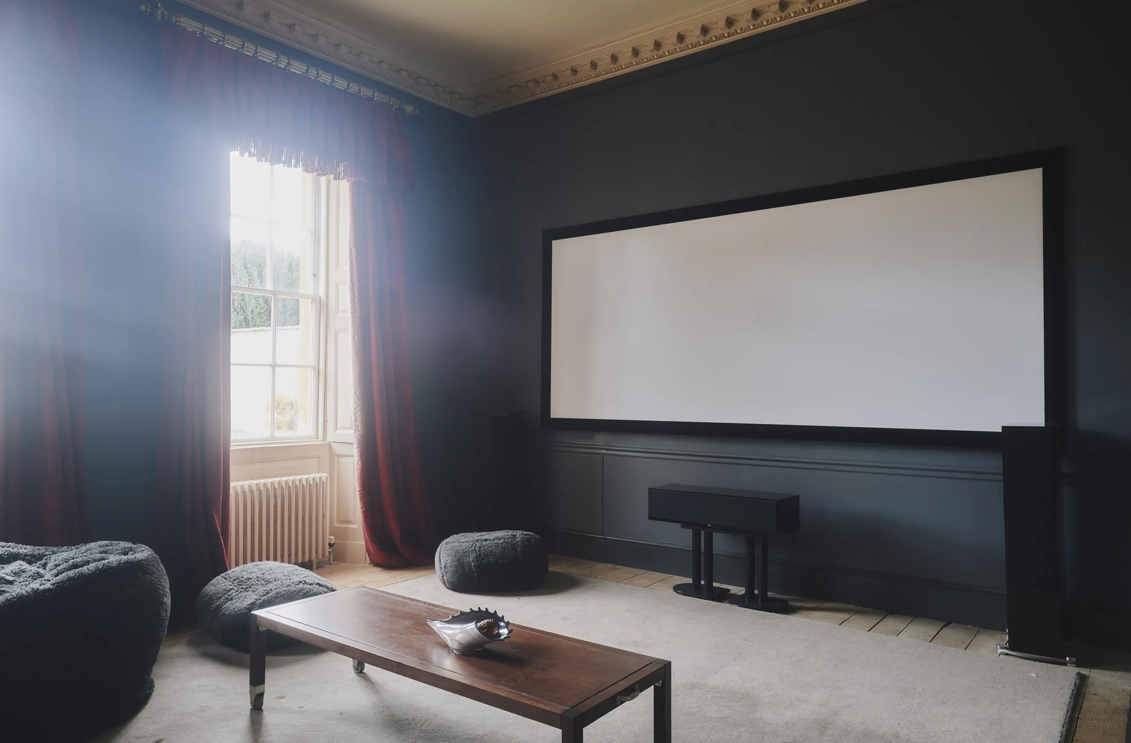 Intimate home cinema with plush seating and ambient lighting at Havenwood, a Domus Stay luxury countryside retreat in The Cotswolds.