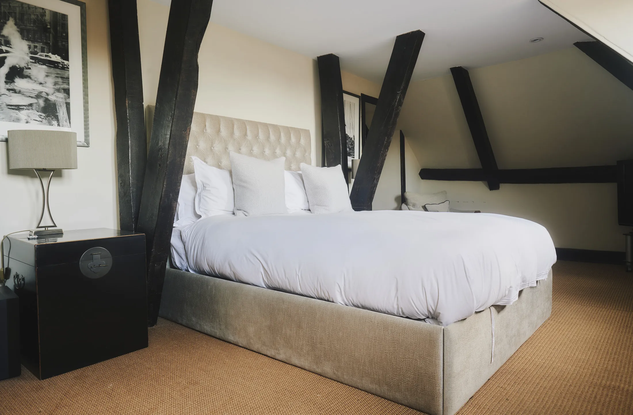 Spacious bedroom with exposed timber beams and crisp white linens at Havenwood, a Domus Stay luxury short stay in The Cotswolds.