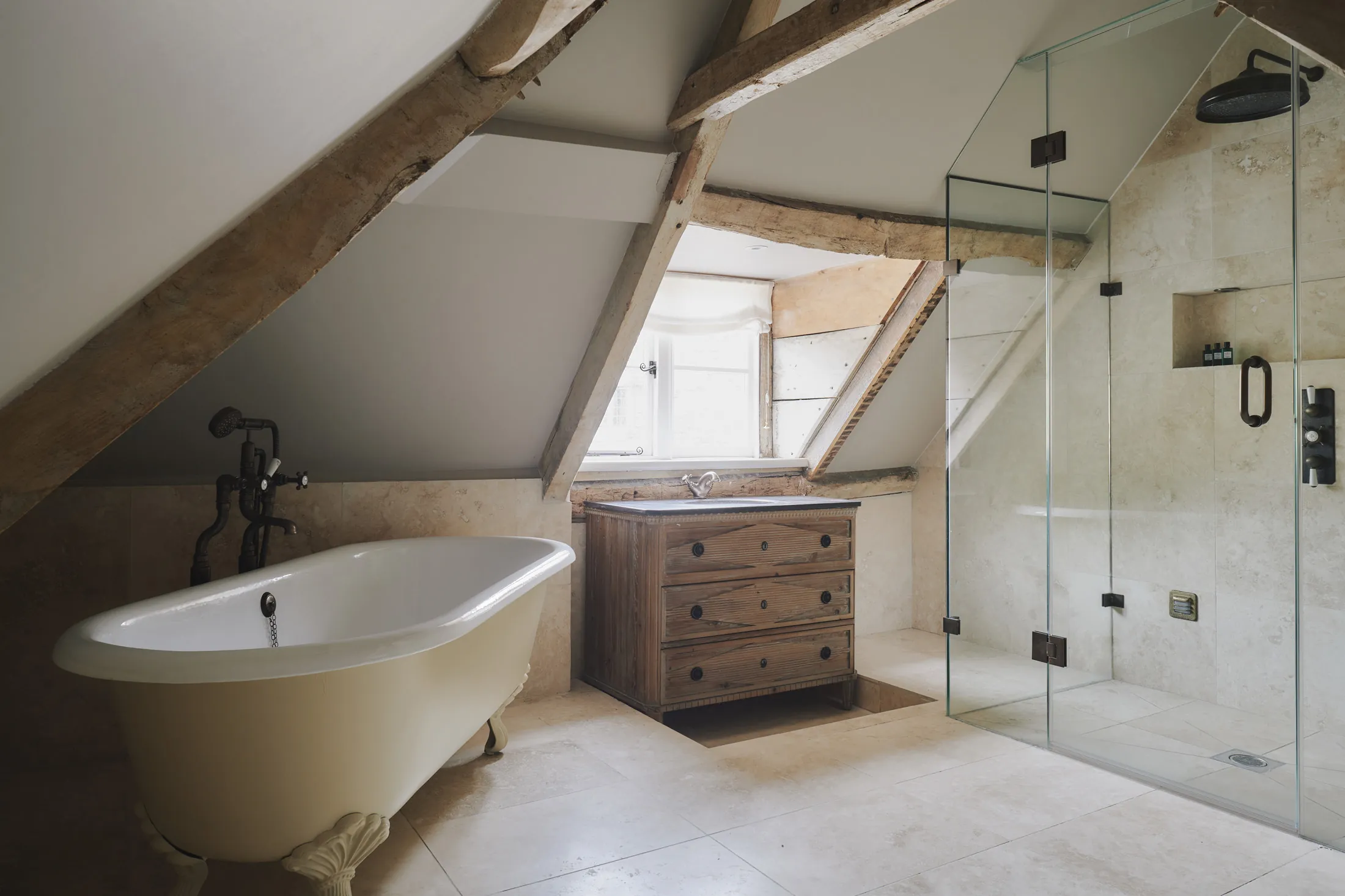 Characterful bathroom featuring clawfoot tub and exposed beams at Havenwood, a Domus Stay luxury getaway.
