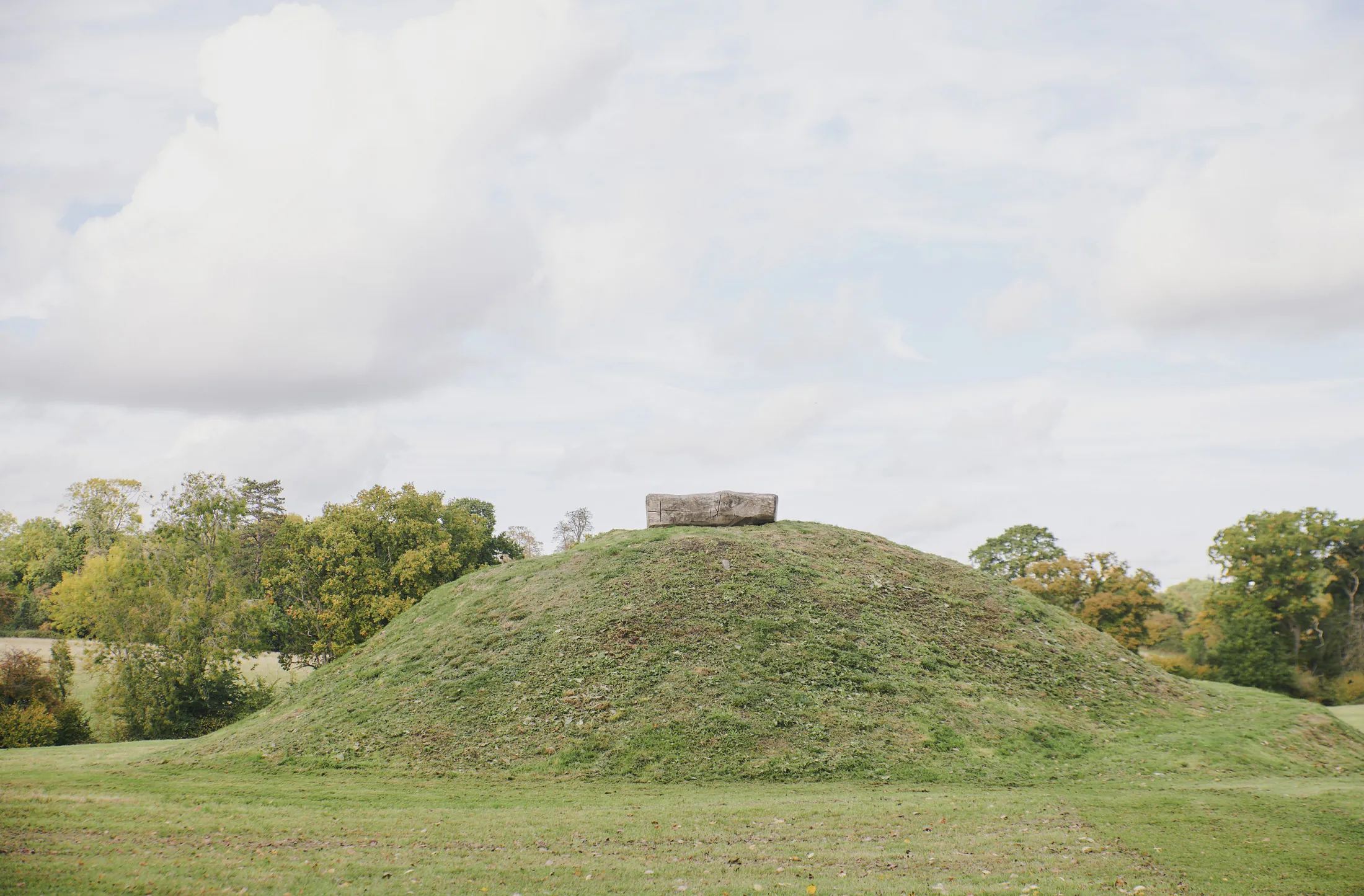 Ancient burial mound with standing stone set within the grounds at Havenwood luxury short stay property in The Cotswolds.