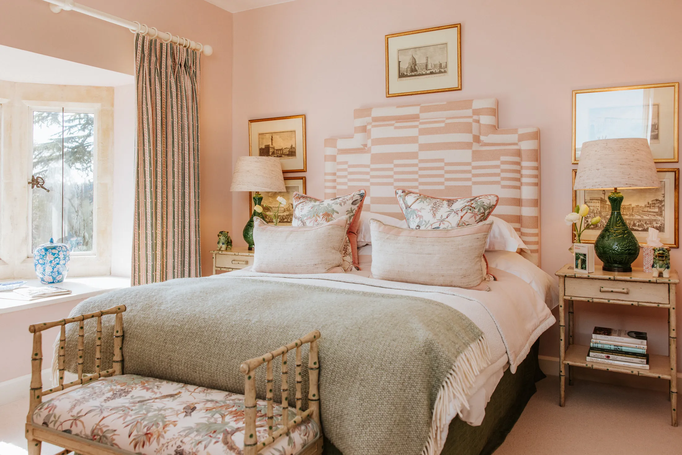 Serene pink bedroom at Coombe End, one of Domus Stay’s luxury short-stay homes, with a statement geometric headboard, layered textures and soft florals.