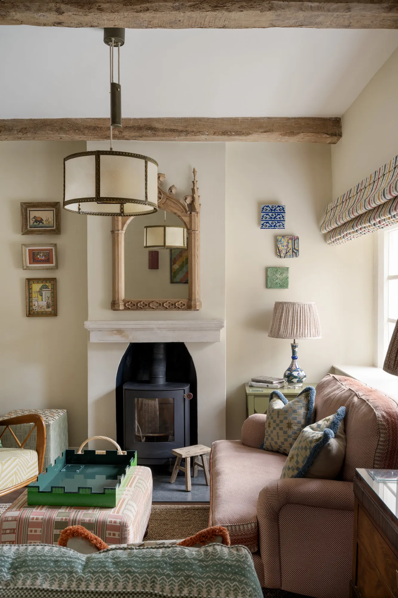 Characterful snug at Winterbourne House with a wood-burning stove, patterned textiles and rustic beams, offered by Domus Stay as a luxury short stay rental in The Cotswolds.