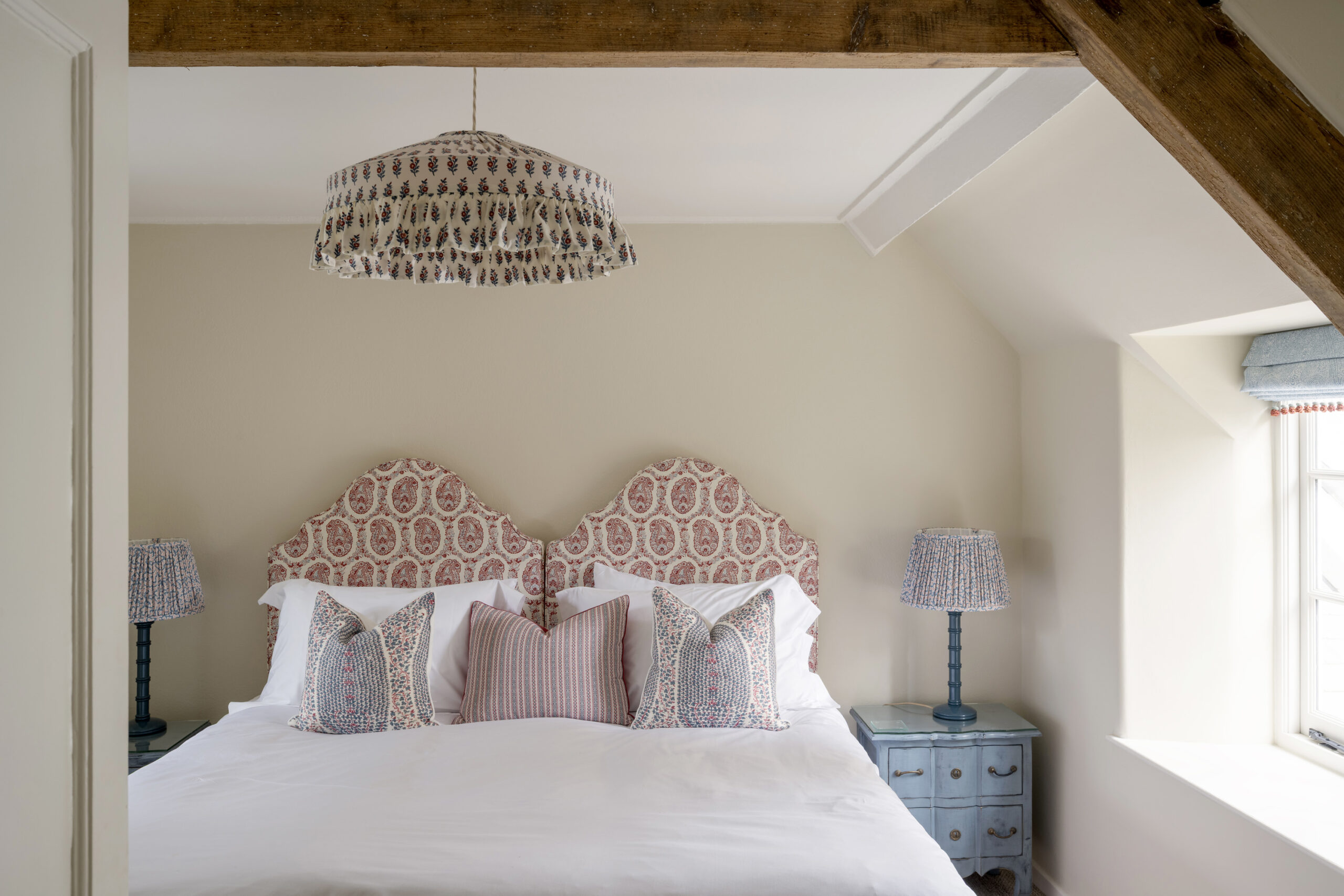 Stow-the-Wold–style bedroom at Winterbourne House, featuring patterned headboards, layered cushions and soft lighting, presented by Domus Stay as a luxury short stay rental in The Cotswolds.