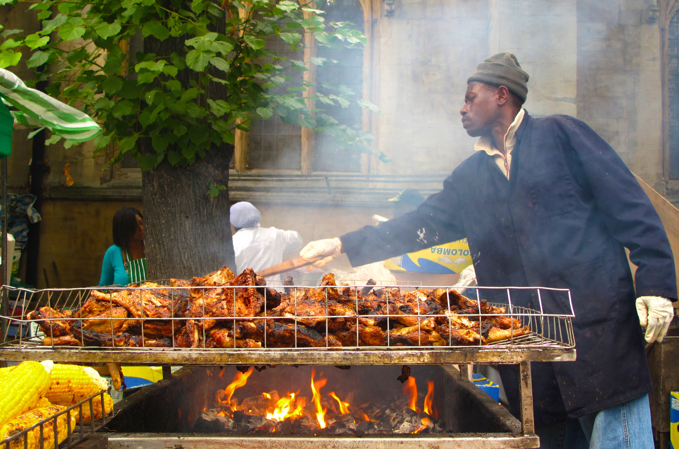Man cooking jerk chicken at Notting Hill Carnival in London